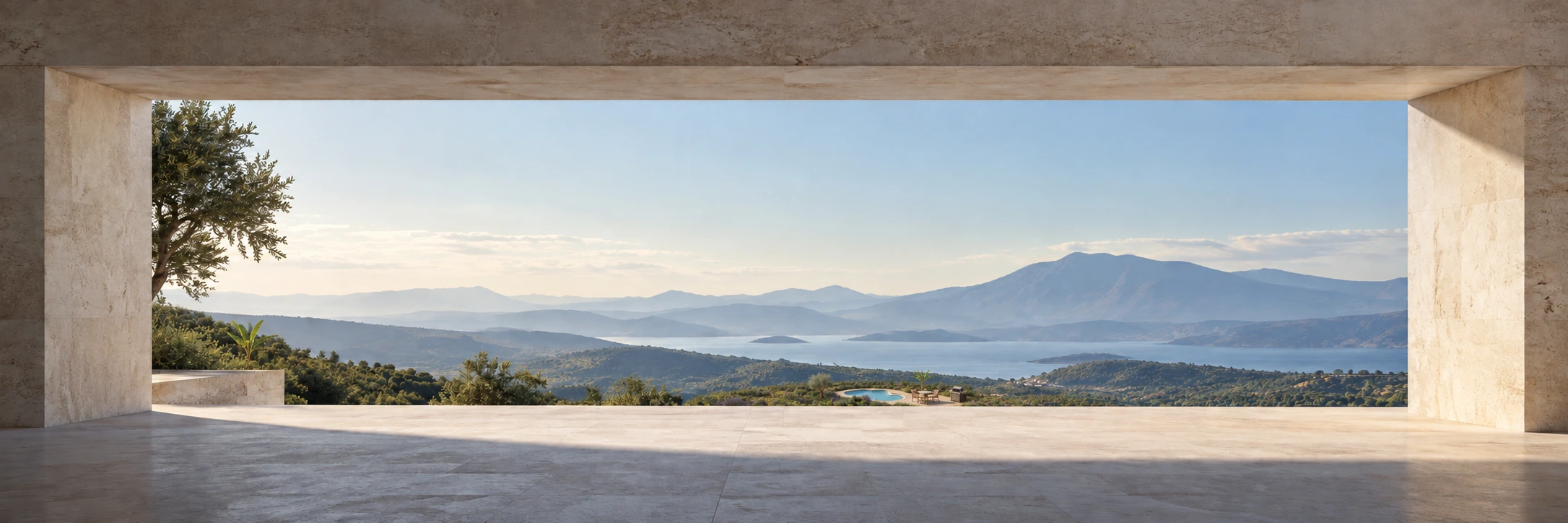 A limestone balcony framing a private garden, water, and distant mountains.